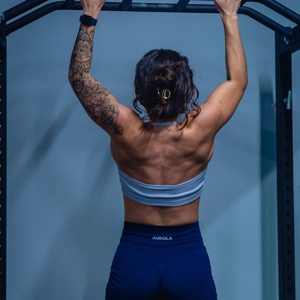 Athletic man back muscles during a strength training pull.