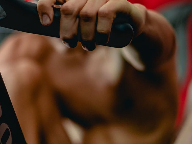 Close up of sports equipment and a man hands during a workout.