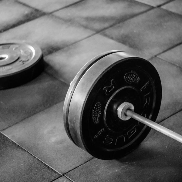 Heavy steel kettlebell on a dark rubber gym floor.