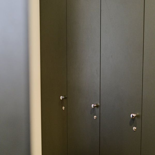 Stopwatch on a wooden bench in a bright gym.